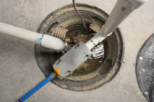 Close up photo of sump pump being worked on in the basement of Bloomington, IL home.