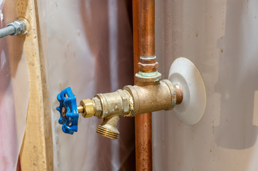 A water heater tank and drain valve.