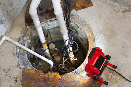 A sump pump with a light pointed toward it.