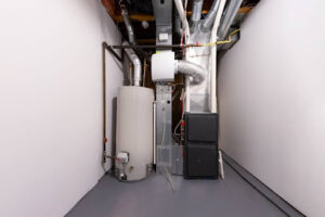 A furnace installed next to a water heater in a house.