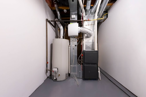 A furnace installed next to a water heater in a house.