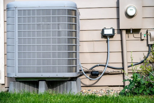 An outdoor AC unit installed along the outside of a house.